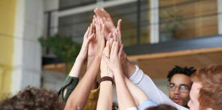 photo of people touching each other s hands