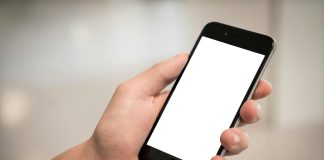 selective focus photography of person holding iphone displaying white screen