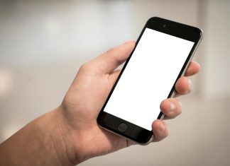 selective focus photography of person holding iphone displaying white screen