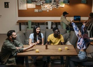 Inside the Thrilling World of the GameZone TableGame Champions Cup smiling friends sitting by table