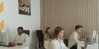 four people working in call center office
