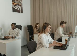 four people working in call center office