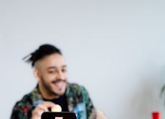 a man recording himself using his phone and tripod