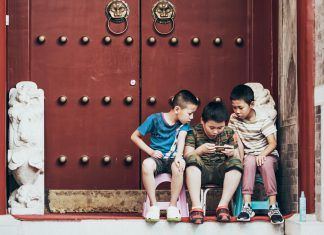 Malaysia’s Budget Gaming Phones Compete Fiercely in the 2025 Market three boys sitting beside door