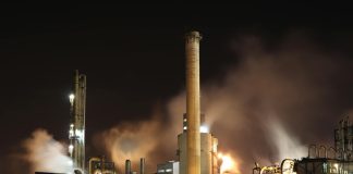 brown and white factory building during night time