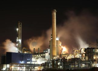 brown and white factory building during night time