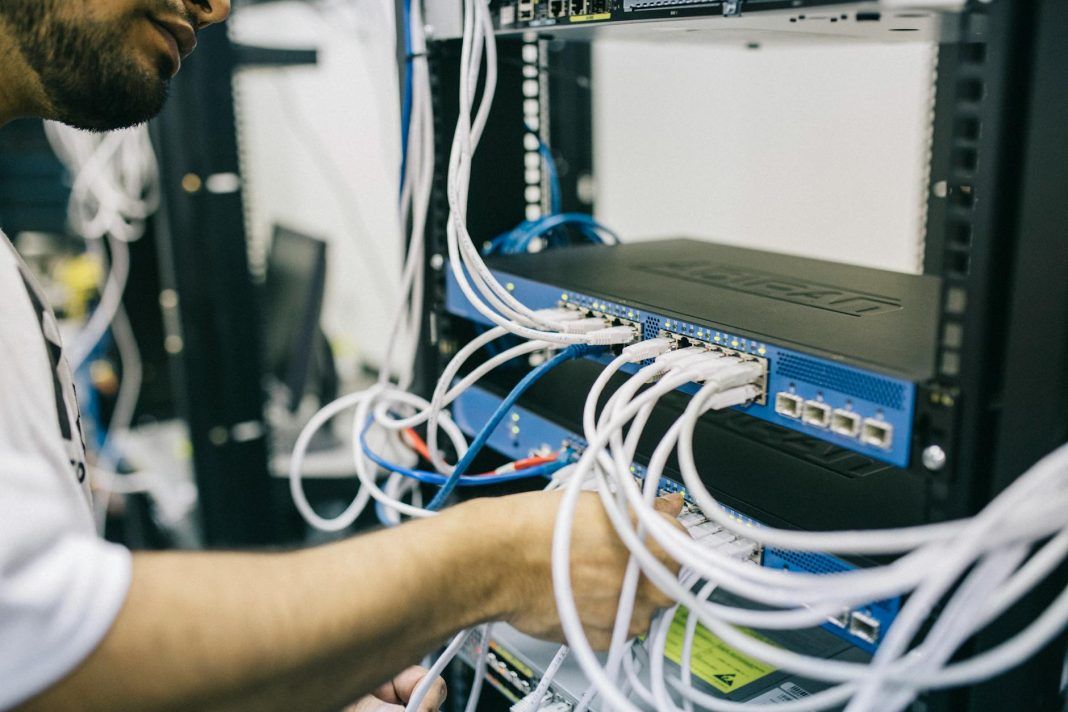 pexels-photo-442150 electronics engineer fixing cables on server
