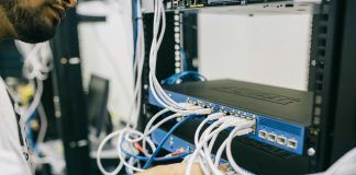 electronics engineer fixing cables on server