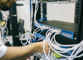 electronics engineer fixing cables on server