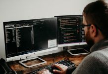 man working on computers coding
