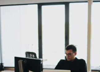 Local app developers enhance user data security features man in black shirt sits behind desk with computers