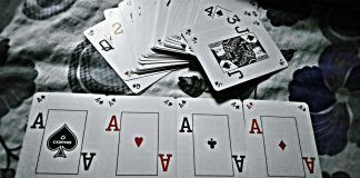 grayscale photography of playing cards placed on cloth