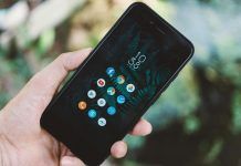 person holding black android smartphone with black case
