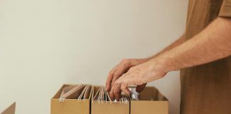 a person looking through a cardboard file organizer