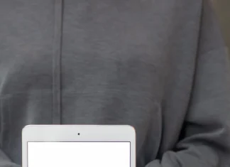How to Bypass iPad Activation Lock (2026 Three Ways) a person holding an ipad