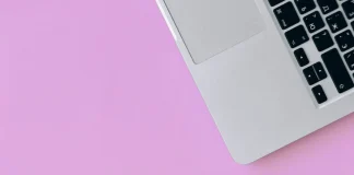 credit cards and a smartphone on a pink surface