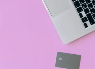 credit cards and a smartphone on a pink surface
